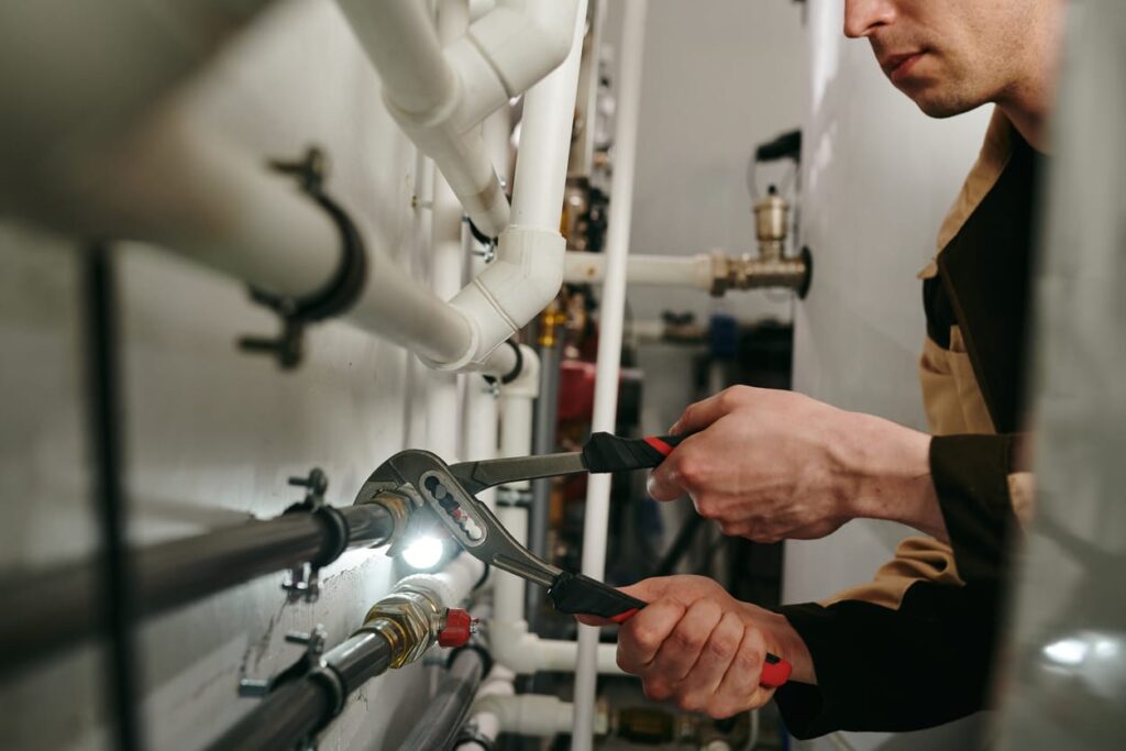 Plumbers maintaining commercial plumbing pipes in Navarre